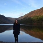Bethany King stands in front of a large lake