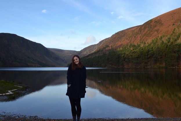 Bethany King stands in front of a large lake