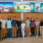 A large group poses for a photo in the Powerhouse