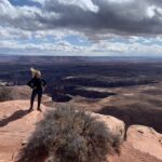 Emily Luetschwager stands in front of a series of canyons