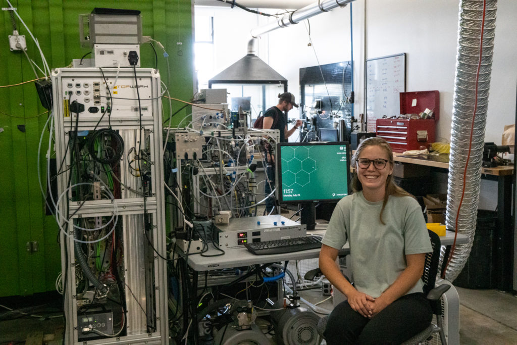 Katelyn Rediger sits in front of a computer in a lab at the Powerhouse