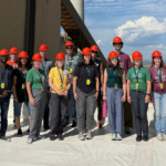 A large group stands on a roof at the Rawhide Energy Station