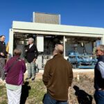 A group on a tour of hydrogen equipment at the Powerhouse Energy Campus.