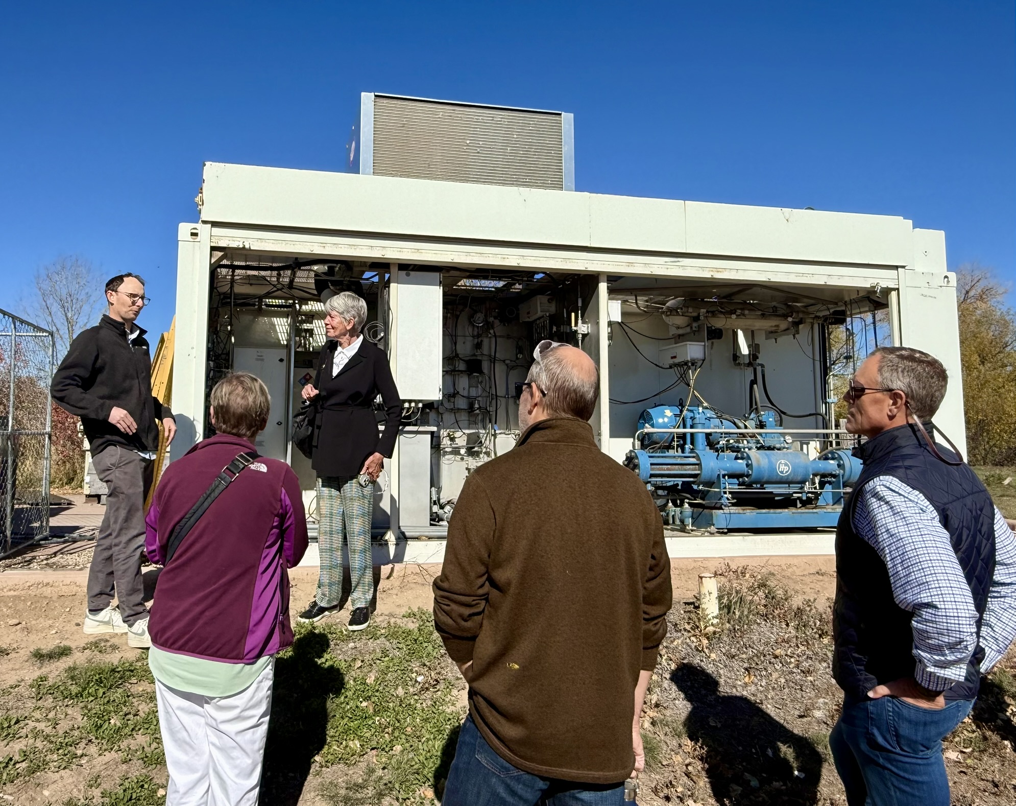 A group on a tour of hydrogen equipment at the Powerhouse Energy Campus.