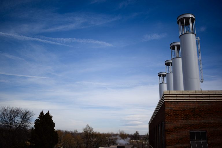 Vertical access wind turbines on top of the Powerhouse in front of a blue sky