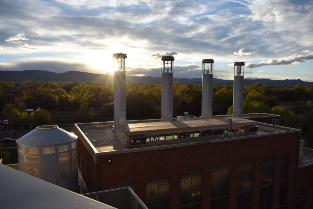 The vertical access wind turbines on top of the Powerhouse at sunset.