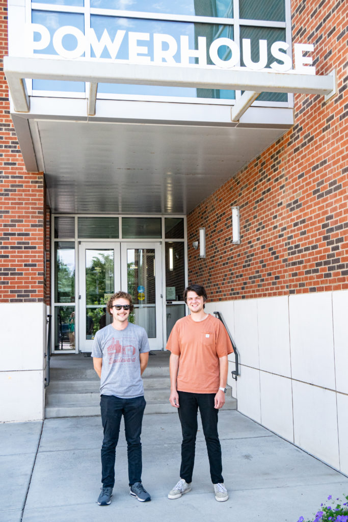 Tucker Melles and Cort Zang stand in front of the Powerhouse