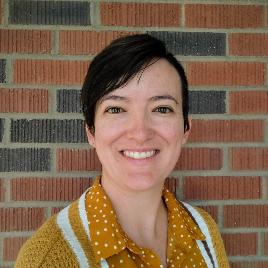 profile photo with brick background yellow polka dot shirt