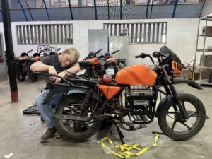 Wesley working on a motorcycle in the Roam factory in Kenya