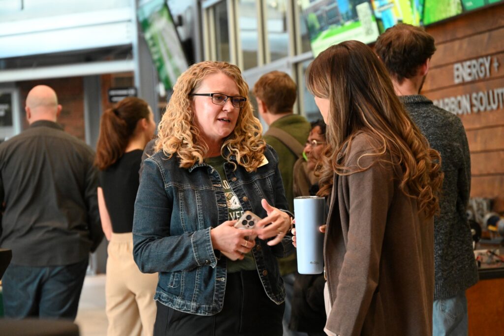 Two women chat at an event in the Powerhouse lobby