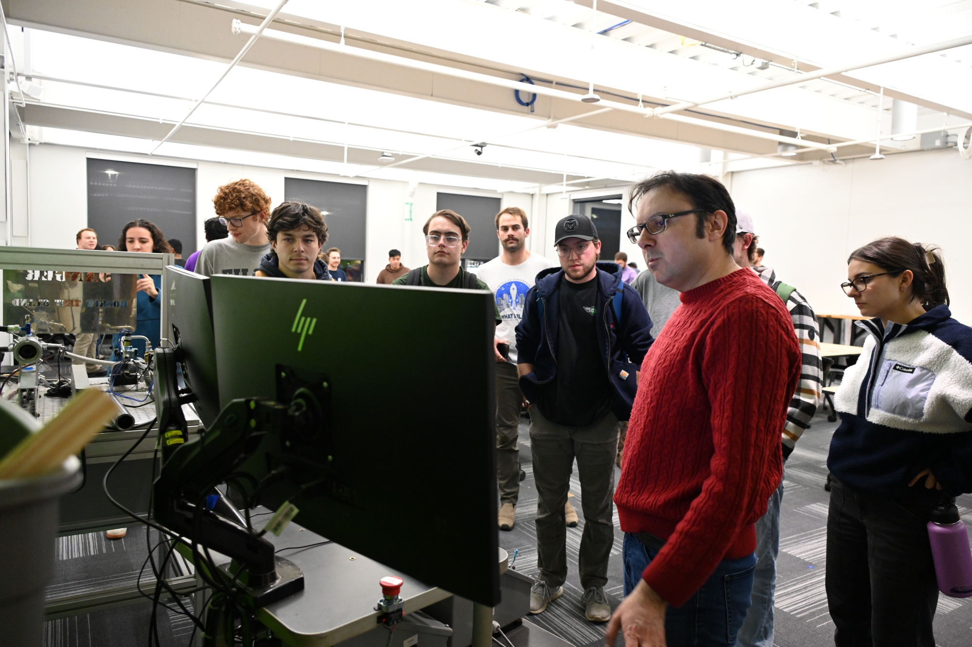 Ciprian shows students the rocket test stand