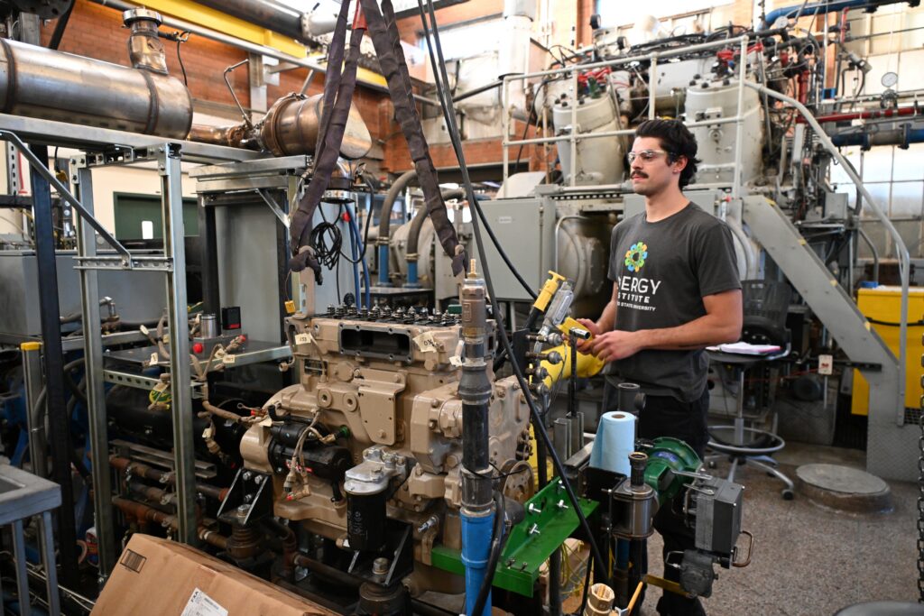 A student works on an engine in the engines and energy conversion lab