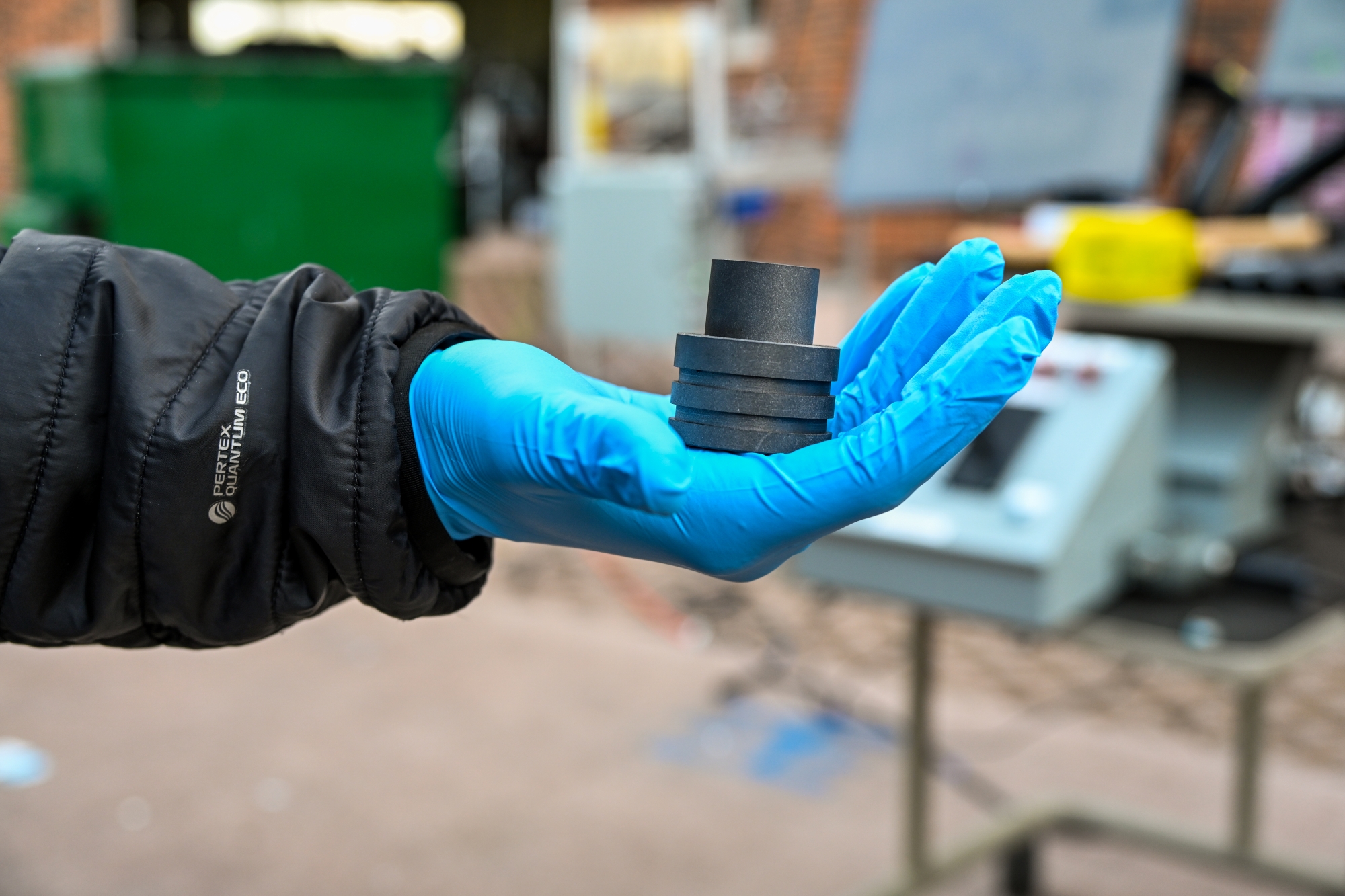 A student holds a graphite nozzle