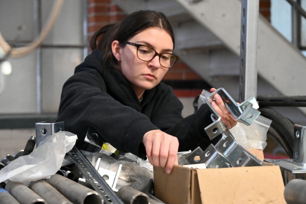 A student sorts parts in the engines and energy conversion lab