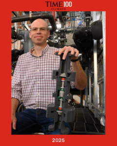 Time100 Climate 2025 frame with Todd holding a model of the AtmosZero equipment