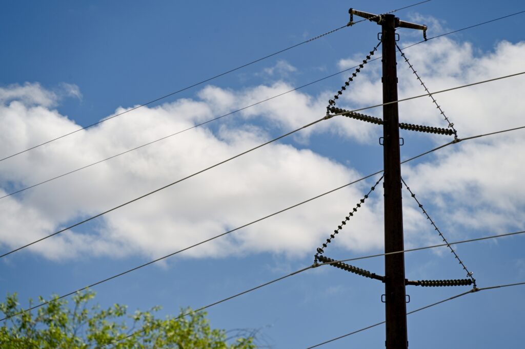 Large powerline with blue sky behind it