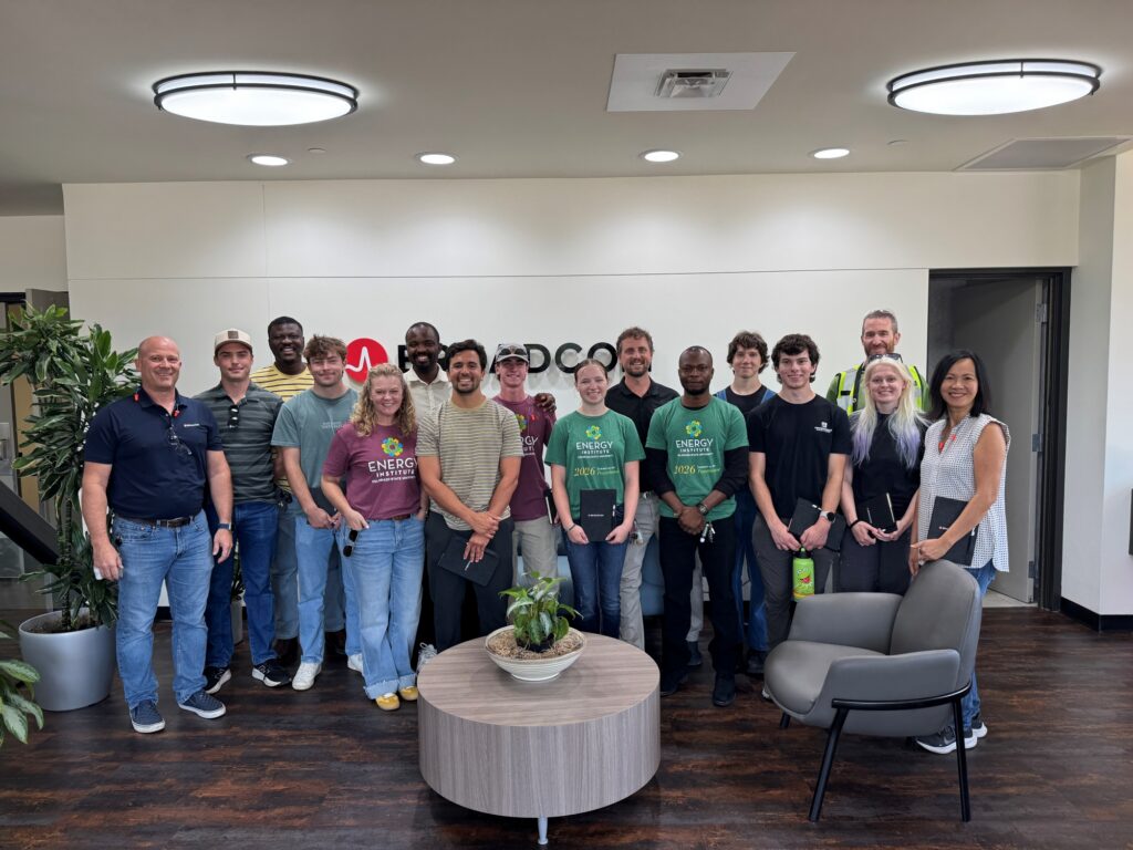 A group from the Powerhouse stands and poses for a photo in the lobby of Broadcom