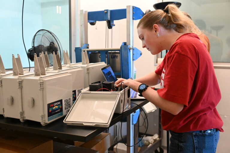 A student preps an CAM unit for shipment out to a research volunteer .